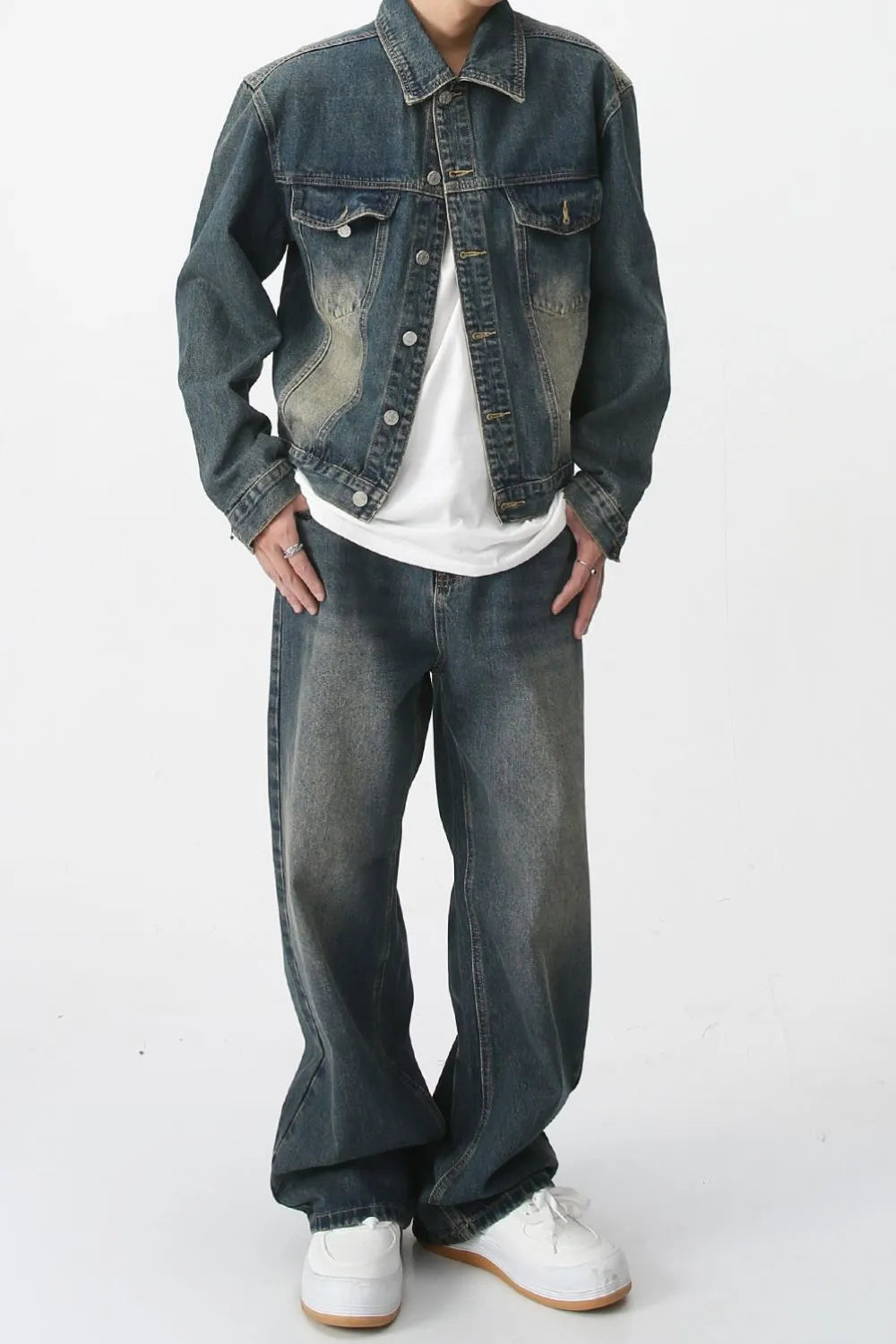 Relaxed fit denim trucker jacket in medium wash with chest pockets and button front.