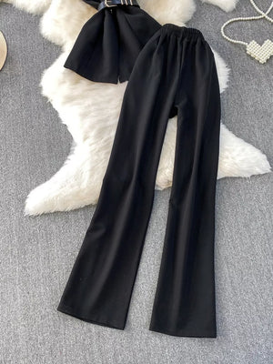 Black belted two-piece set with wide-leg pants and pockets.
