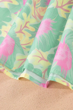 Pastel floral print polyester blouse with ruffled detail and puff sleeves.