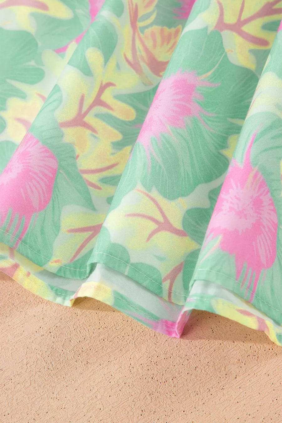 Pastel floral print polyester blouse with ruffled detail and puff sleeves.