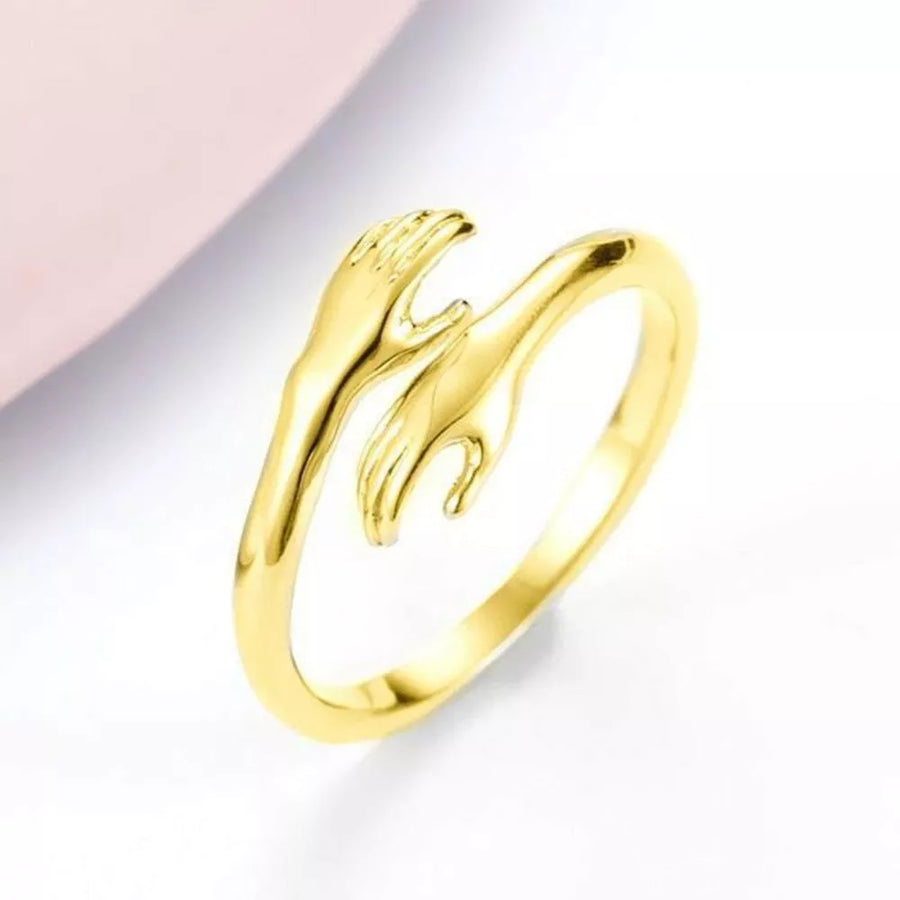 ring in silver with hug design and not applicable