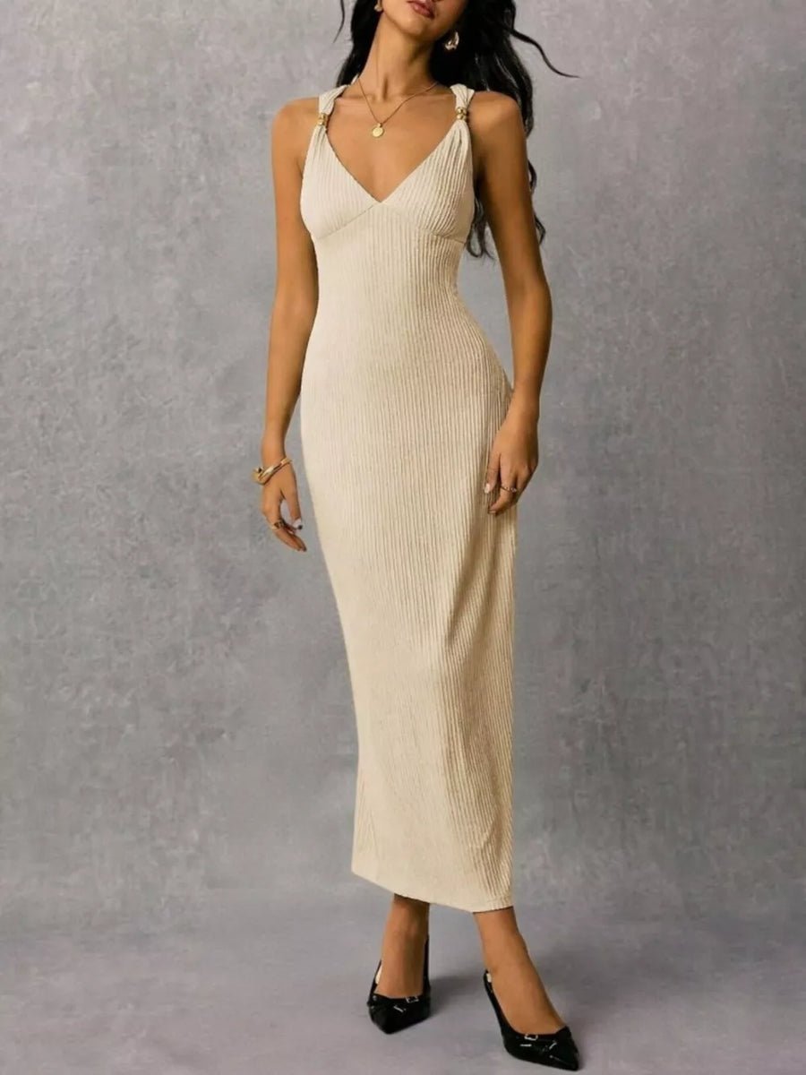 Ivory ribbed midi dress with V-neck and crisscross strap detail.
