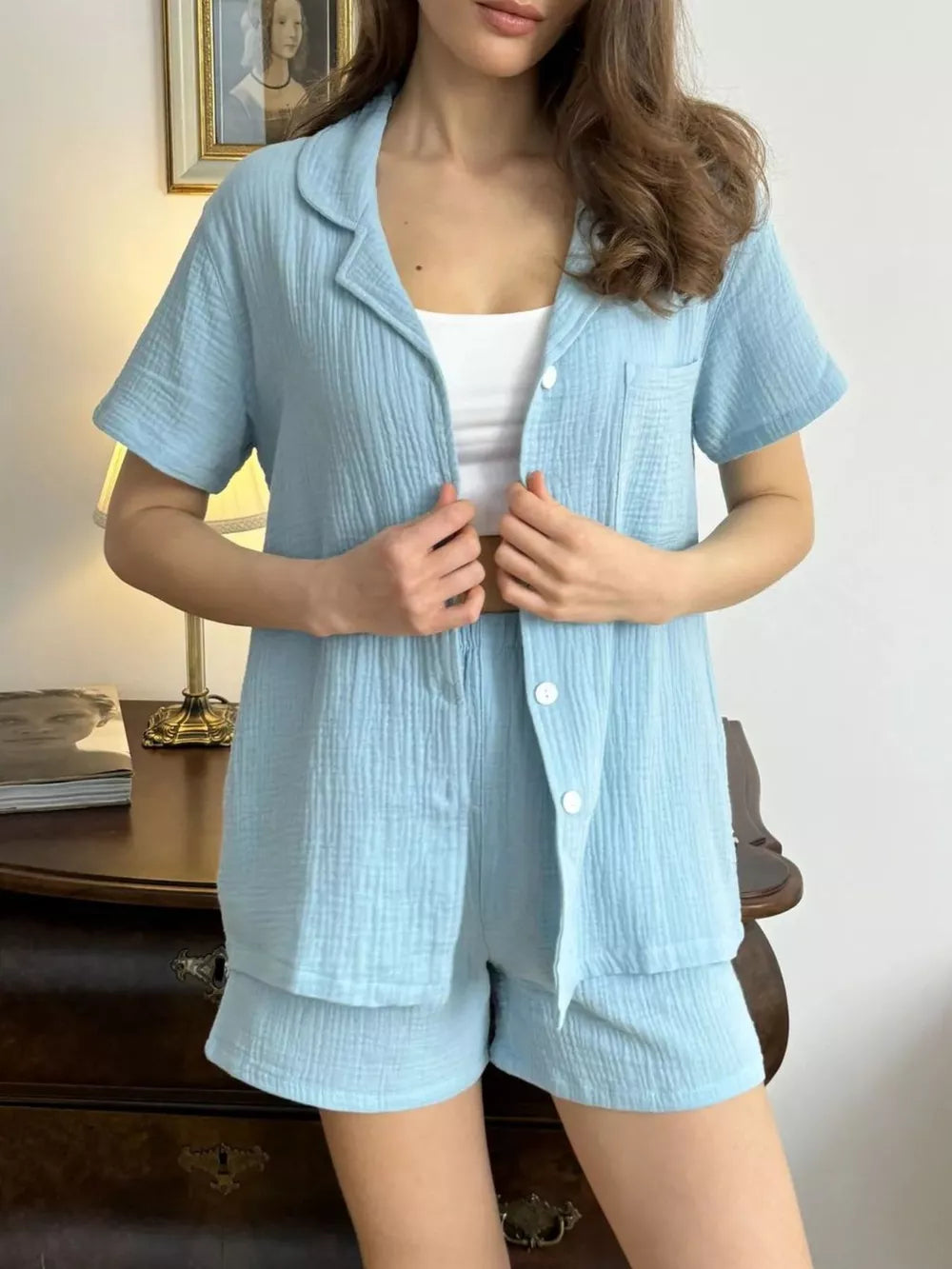 Sky blue cotton pajama set with button-up shirt and shorts.