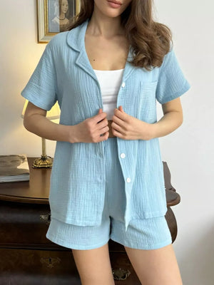 Sky blue cotton pajama set with button-up shirt and shorts.