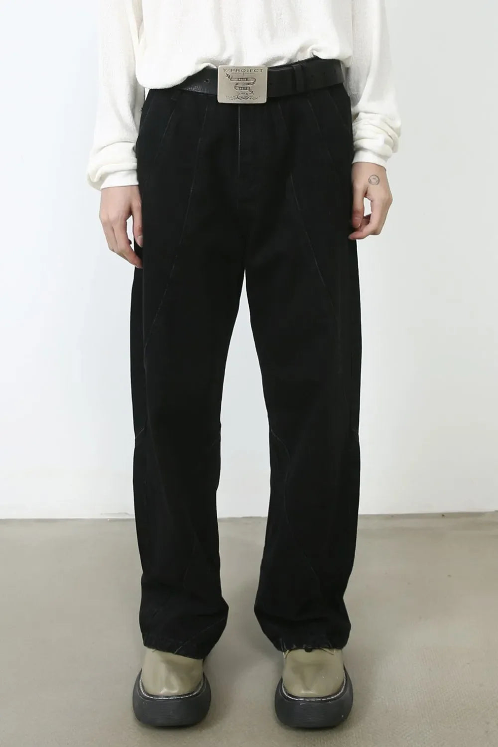 Dark denim trousers with sculpted seams and a relaxed fit.