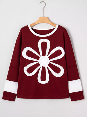 Burgundy long-sleeve top with white flower patch and sleeve bands.