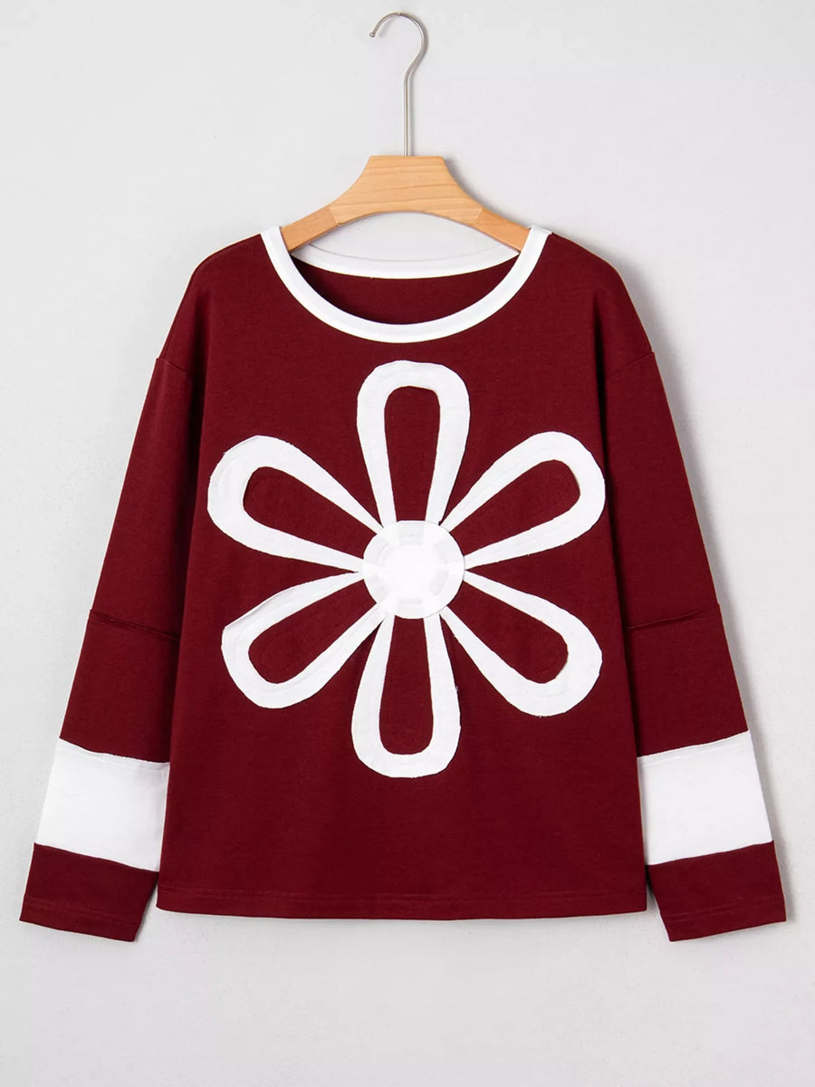 Burgundy long-sleeve top with white flower patch and sleeve bands.