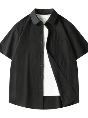 Black short sleeve button-up shirt with pocket, worn over a white t-shirt.