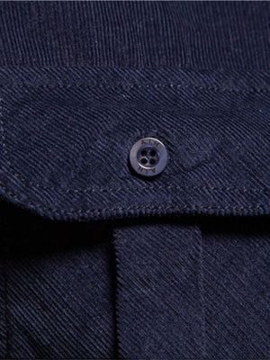 Indigo corduroy utility shirt with button-down closure and patch pocket detail.
