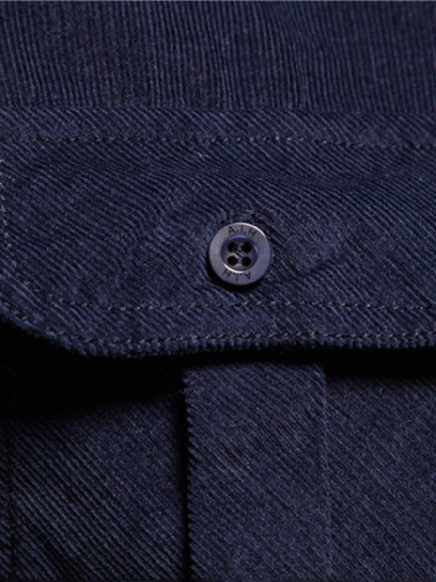 Indigo corduroy utility shirt with button-down closure and patch pocket detail.
