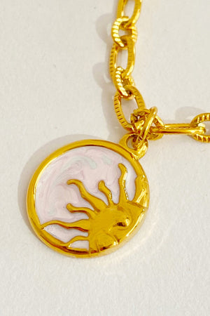 18K gold-plated chain necklace with a sun charm featuring a marbled pink and white enamel background.