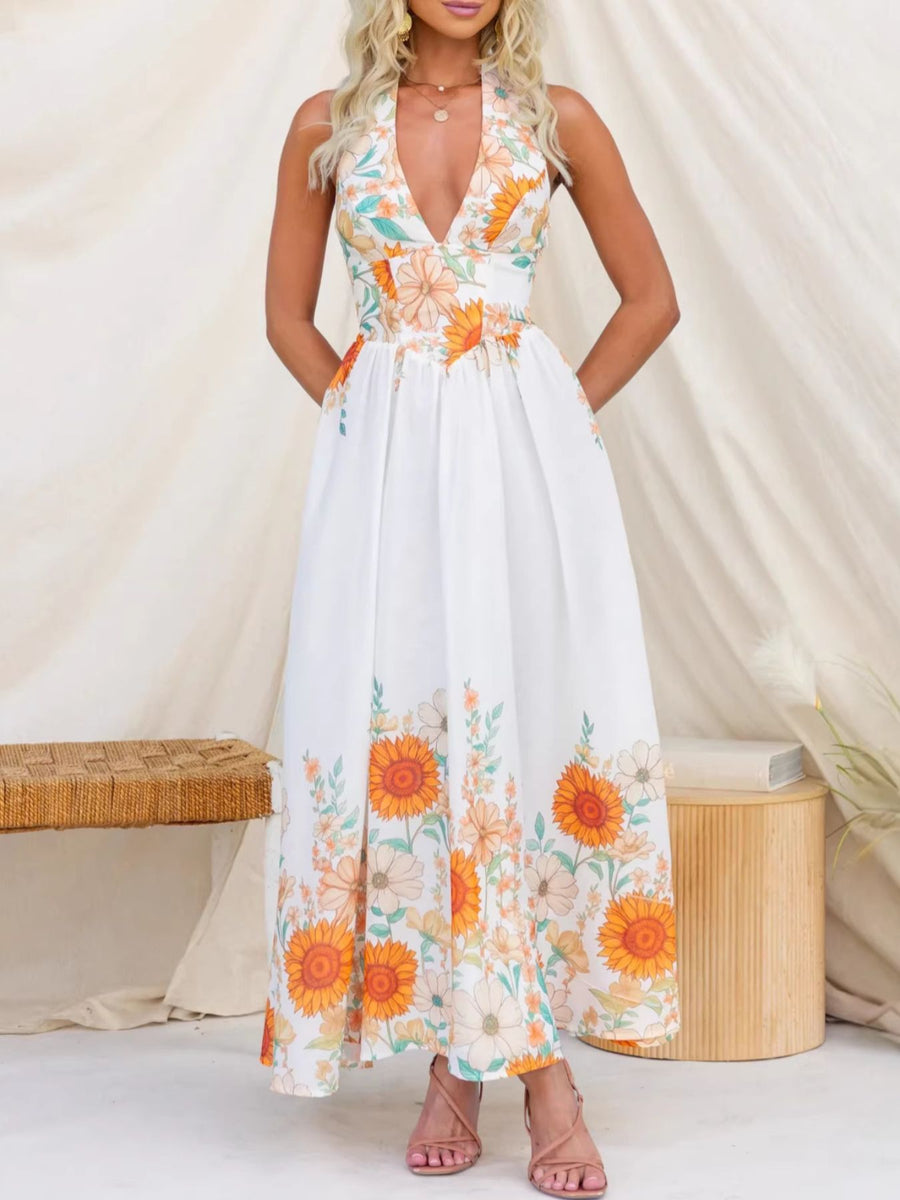 White floral halter neck maxi dress with a deep V-neck and tiered skirt.