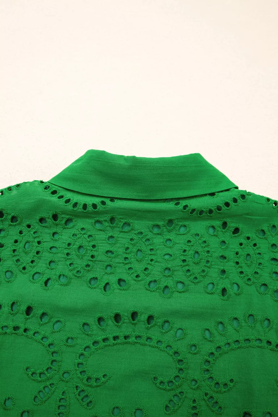 Green cotton eyelet collared dress with intricate cutwork detail.