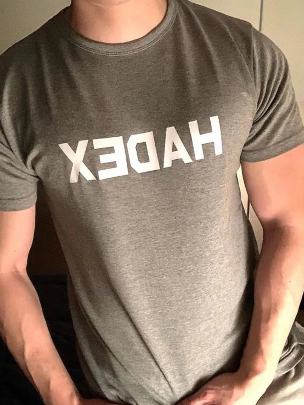 Gray crewneck t-shirt with reversed white graphic text on chest