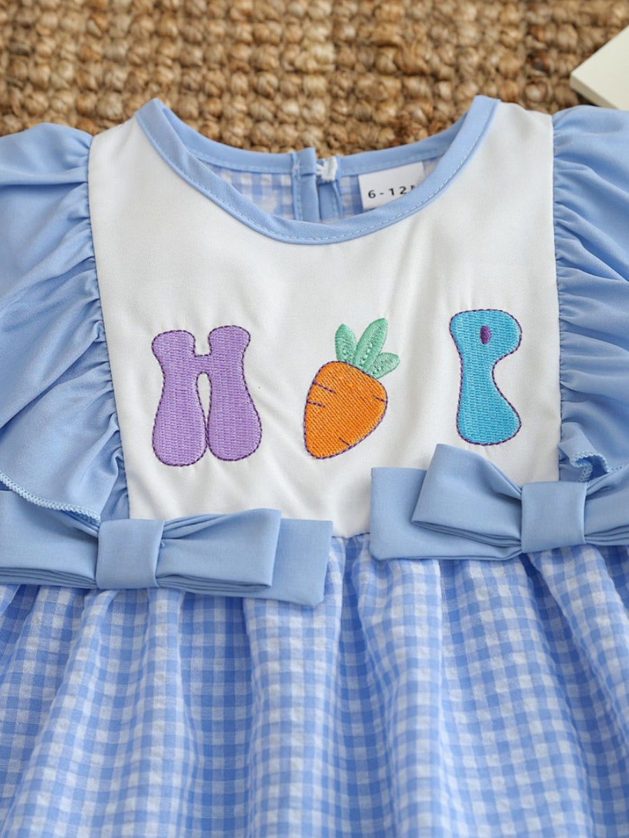 Baby set with blue gingham skirt, white bib with carrot embroidery, and bow details.