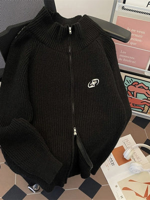 Black ribbed zip-up sweater with mock neck and long sleeves