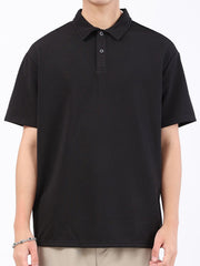 Black textured performance polo shirt with short sleeves and a two-button placket.