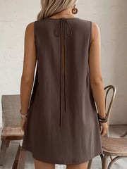 Coffee brown sleeveless dress with tie-back detail and frill accents.
