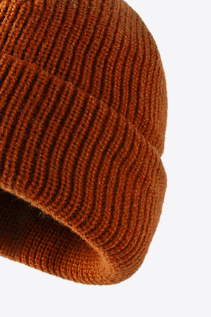 Folded edge ribbed knit beanie in brown acrylic with vertical ribbing detail.