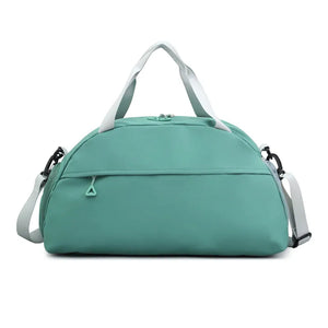 Turquoise duffel bag with white straps and detachable shoulder strap.
