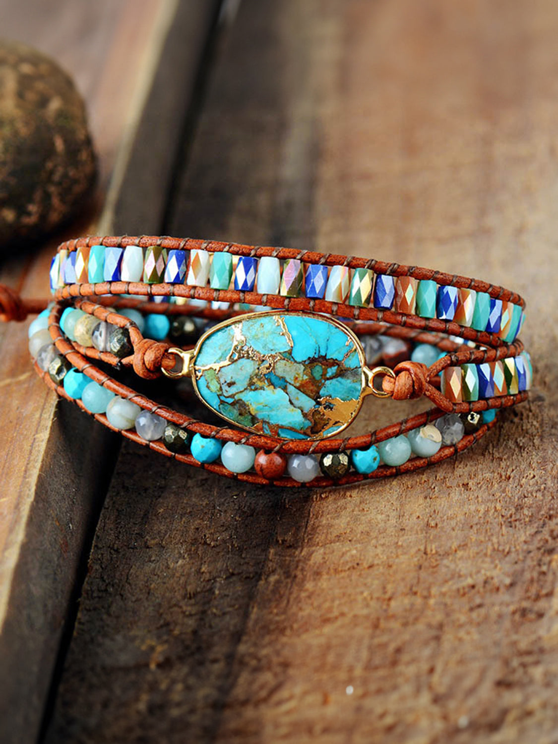 Aqua stone and leather wrap bracelet with multi-colored beads and gold accents.