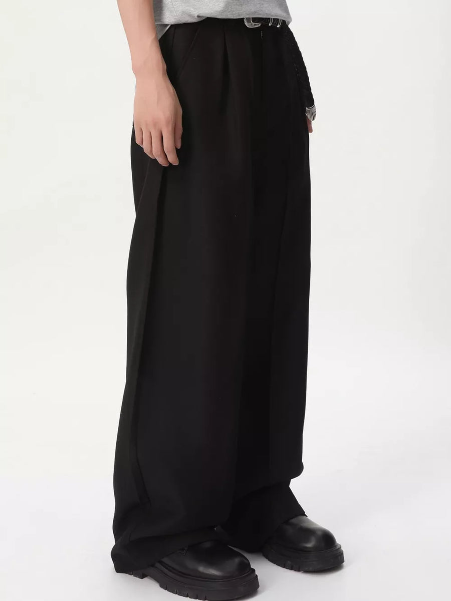 Black relaxed wide-leg pleated trousers with a loose fit and visible stitching detail.