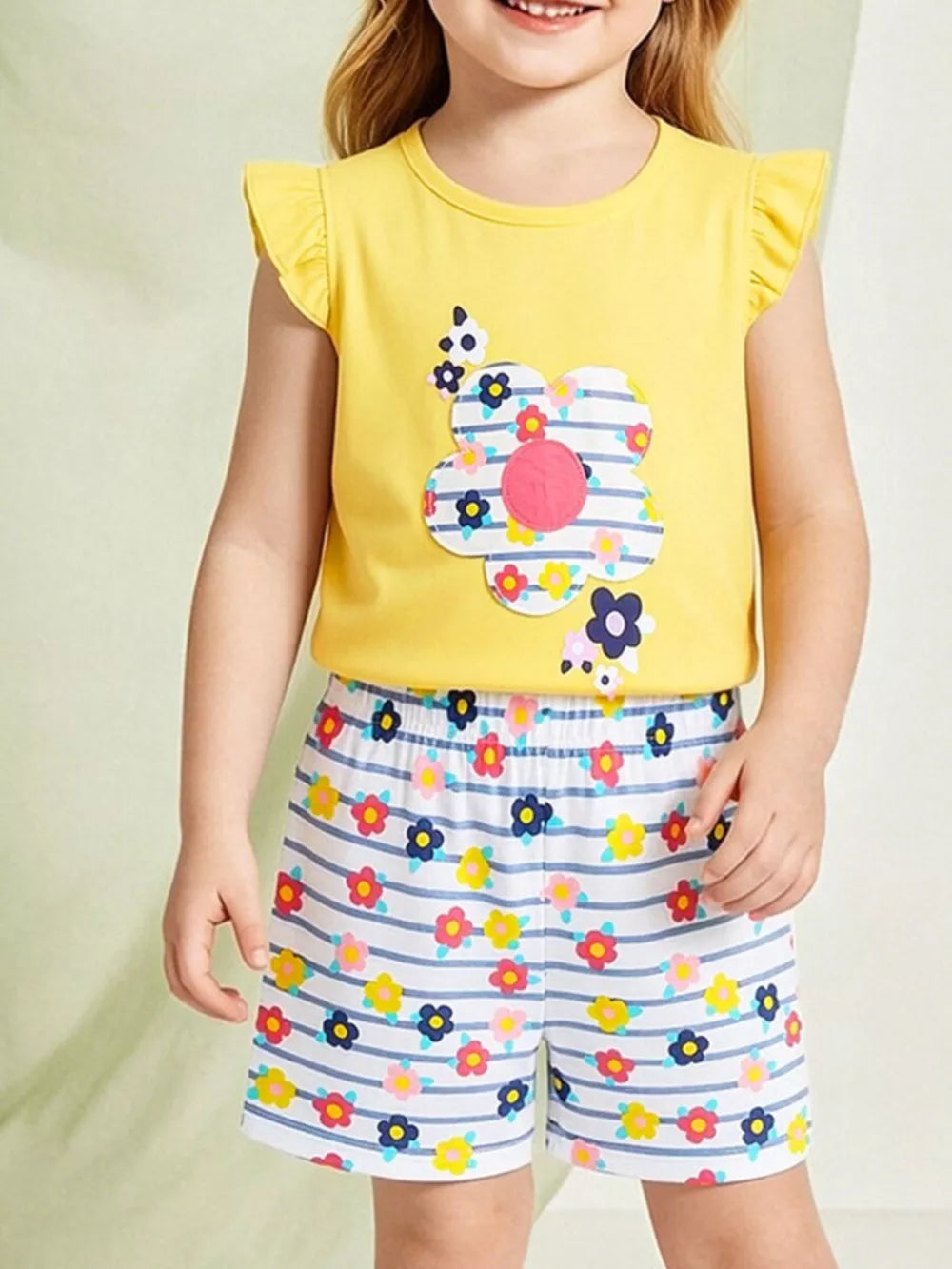 Toddler yellow cotton set with floral applique top and striped floral shorts.