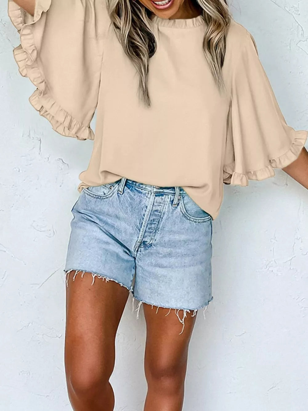 Apricot ruffled mock neck half sleeve shirt with bell sleeves.