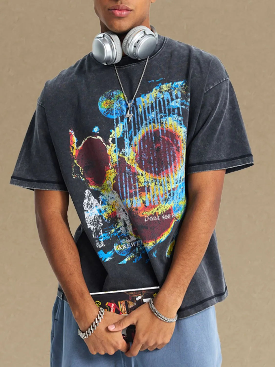 Acid wash graphic t-shirt in black with a colorful skull print and short sleeves.