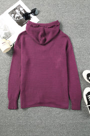 Burgundy textured knit hooded pullover sweater with fringe trim on hood.