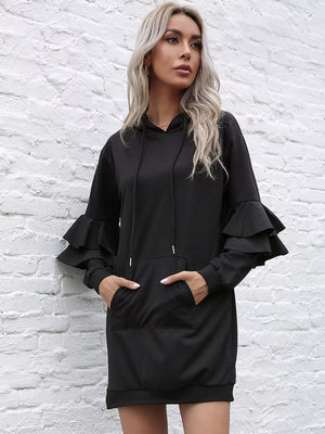 Black hooded mini dress with ruffle trim sleeves and a front pocket.