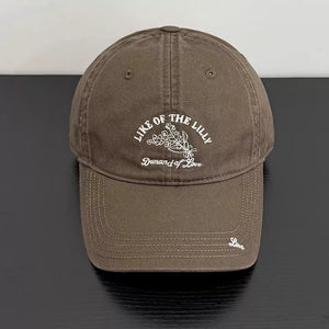 Khaki cotton cap with floral embroidery and text detail