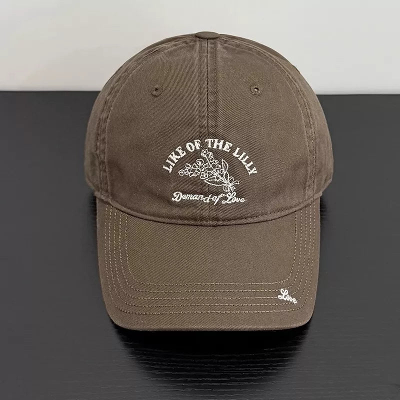 Khaki cotton cap with floral embroidery and text detail