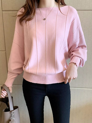 pullover sweater in light pink featuring ribbed hem and relaxed fit