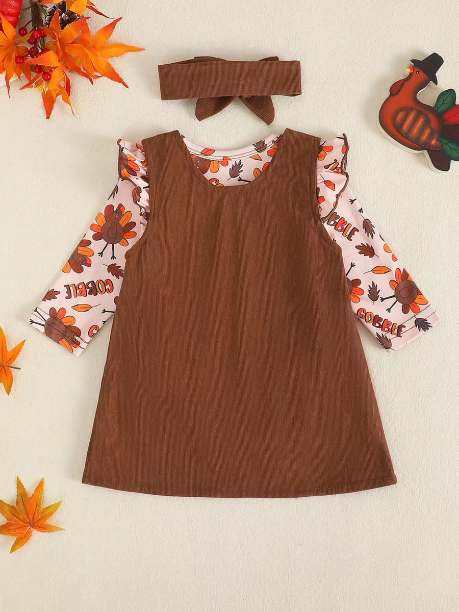 Brown corduroy turkey dress and bodysuit set with ruffled sleeves and headband.