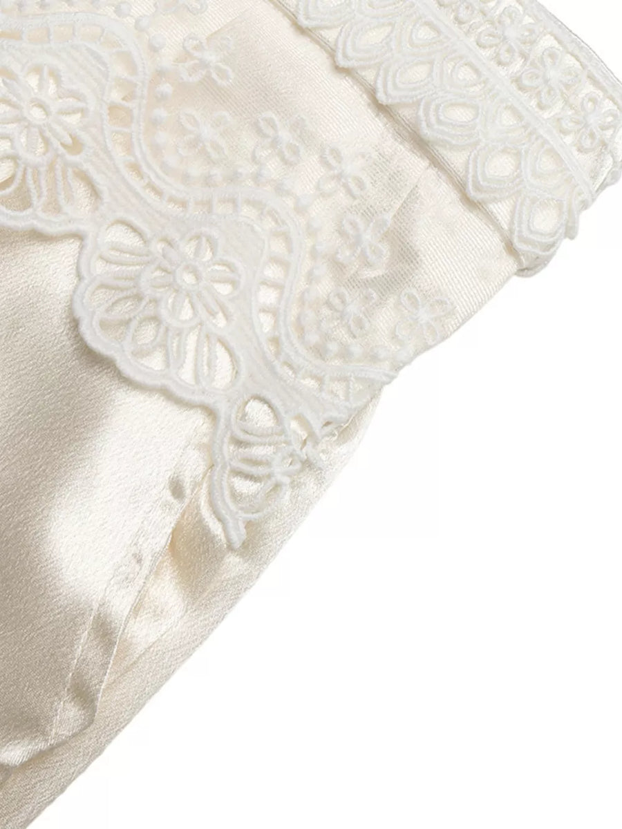 Lace-trimmed beige maternity wide-leg trousers with a high waist.
