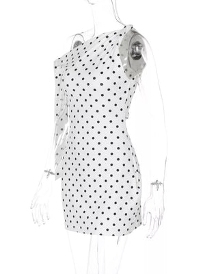 White polka dot mini dress with asymmetrical one-shoulder design and long sleeve.
