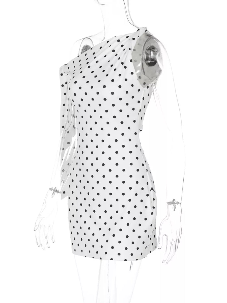 White polka dot mini dress with asymmetrical one-shoulder design and long sleeve.