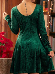 Green velvet a-line gown with long sleeves and a round neckline, shown from the back.