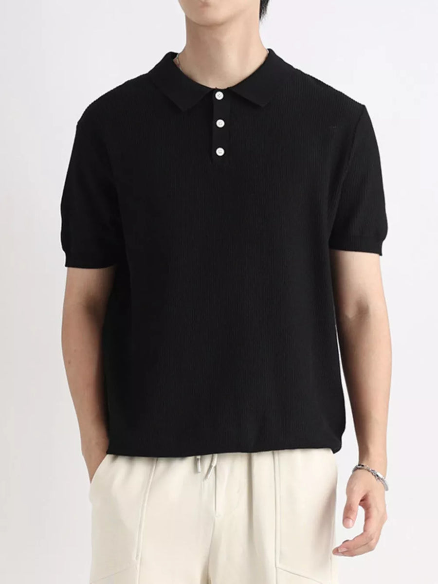 Black ribbed short sleeve polo shirt with classic collar and three white buttons.