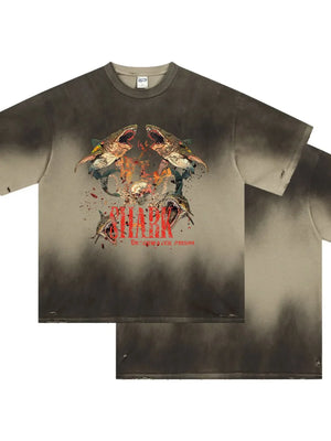 Distressed khaki t-shirt with a bold shark graphic and distressed details.