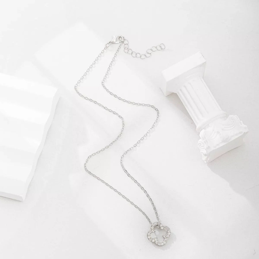 Silver clover pendant necklace with clear stones on a delicate chain