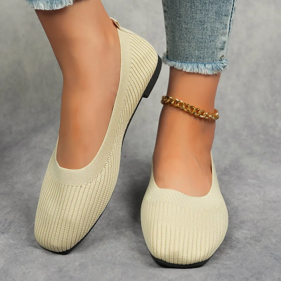 Beige knit square toe flats with a subtle ribbed texture and a gold chain anklet.
