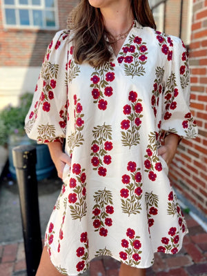 V-neck mini dress with pockets in cream cotton with red floral print and puff sleeves
