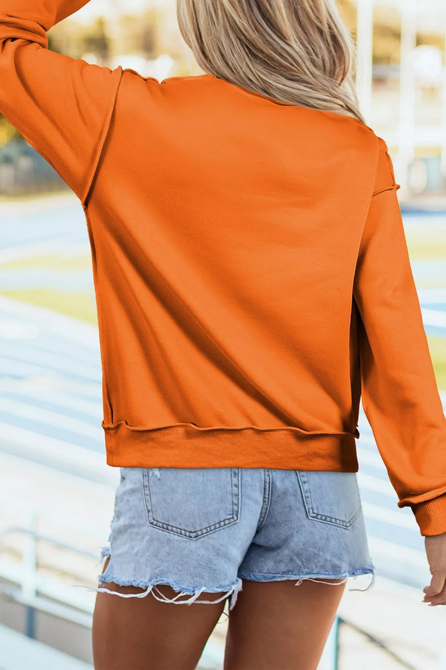 Orange sweatshirt featuring reversible and graphic-print