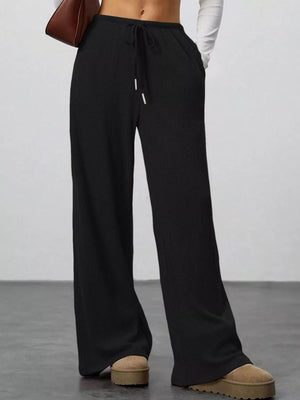 Black ribbed wide-leg pants with drawstring waist and pockets