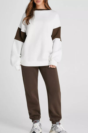 Oversized white sweatshirt with chocolate contrast sleeves and collar, paired with chocolate sweatpants.