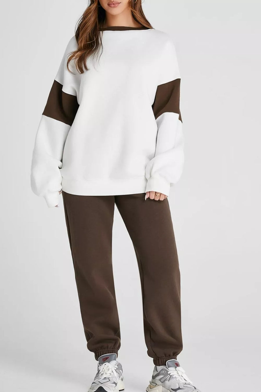 Oversized white sweatshirt with chocolate contrast sleeves and collar, paired with chocolate sweatpants.