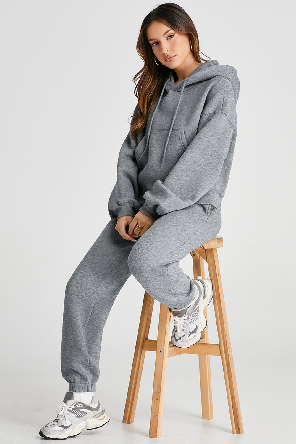 Gray relaxed fit loungewear set with hoodie and drawstring pants, featuring a front pocket.