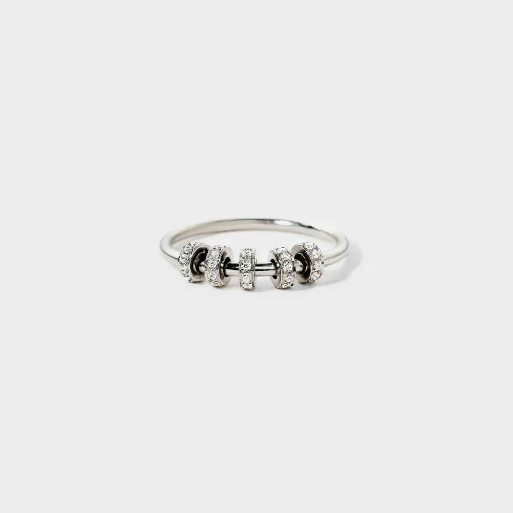 Sterling silver ring with five circular charms, each encrusted with small clear stones.